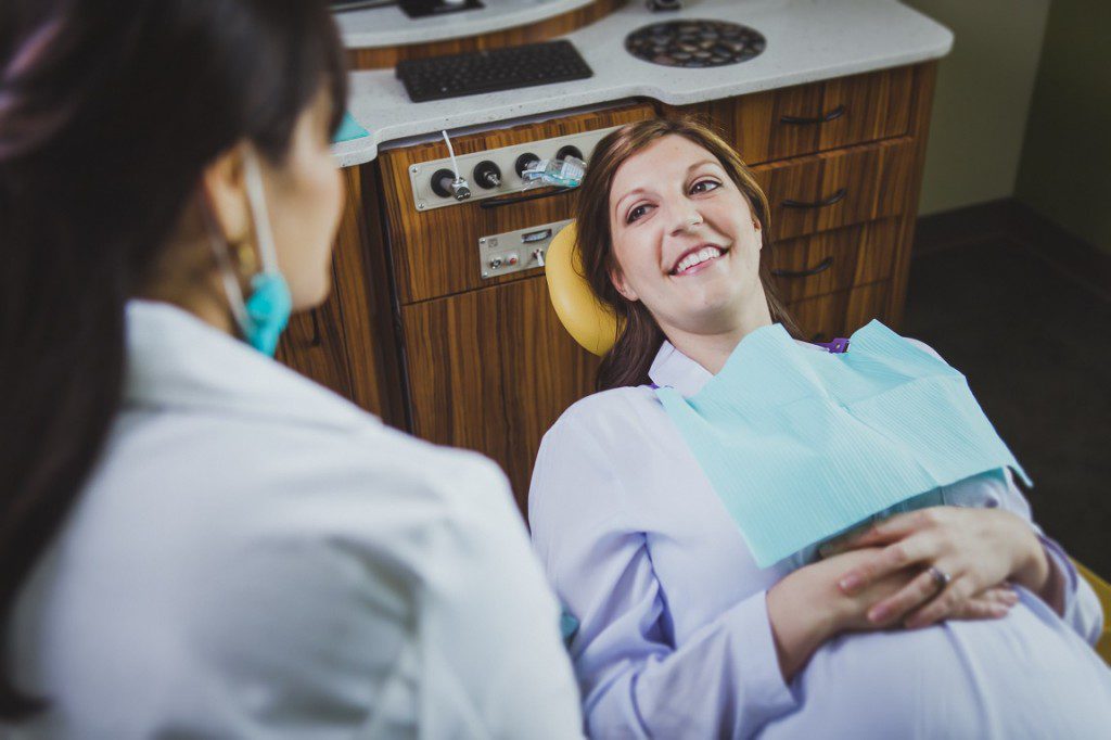 pregnant at dentist laying in chair