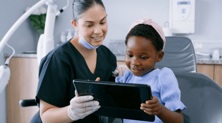 Dental assistant helping a child at the dentist.