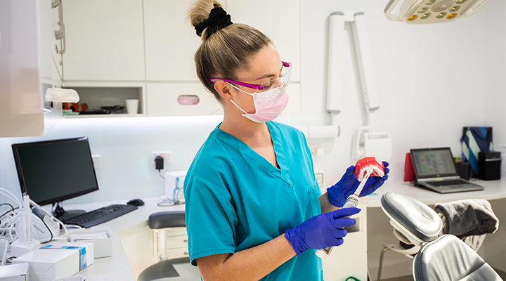 A dental assistant prepares for the next dental appointment.
