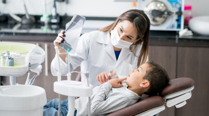 Woman dentist with young patient