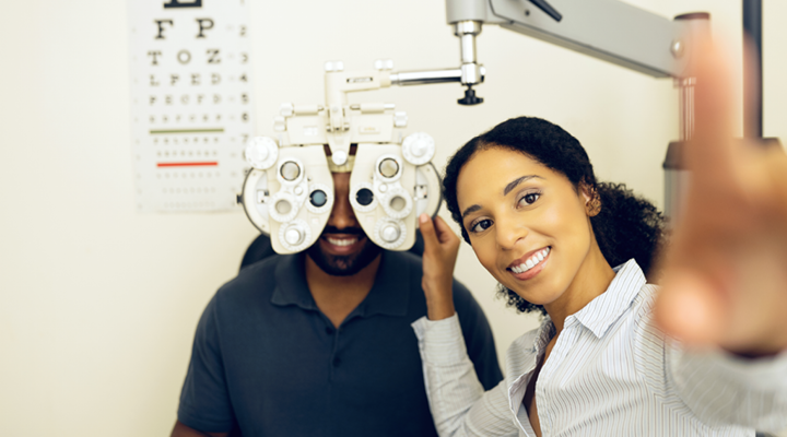 Person smiling and getting their vision checked.