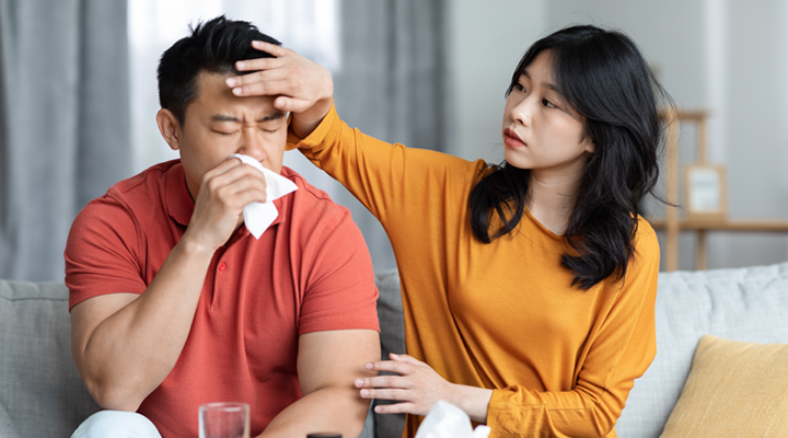 Woman taking care of a sick man.
