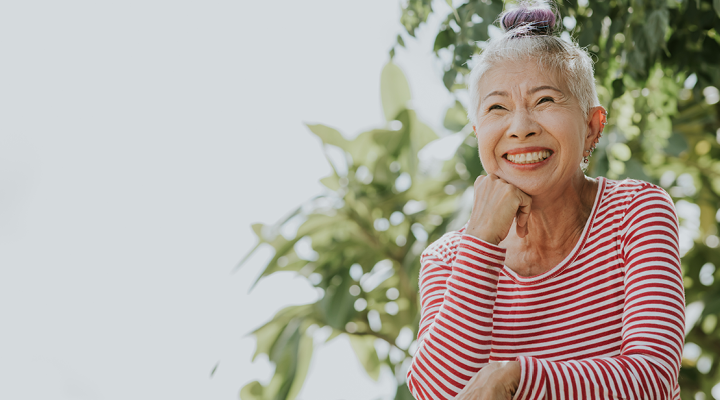 Older adult smiling in the sun.