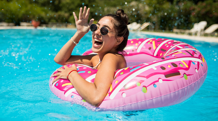 Person smiling and laughing in the pool.