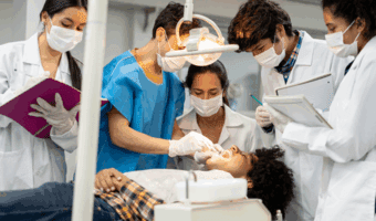 Group of dental students performing a dental exam.