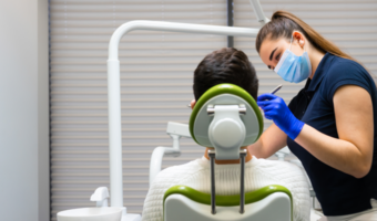 Dental assistant working on a patient in the dental chair.