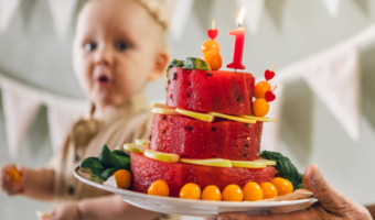 Child looking at a delicious watermelon cake.