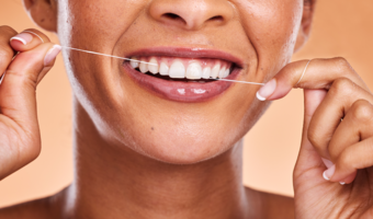 Person smiling and flossing.